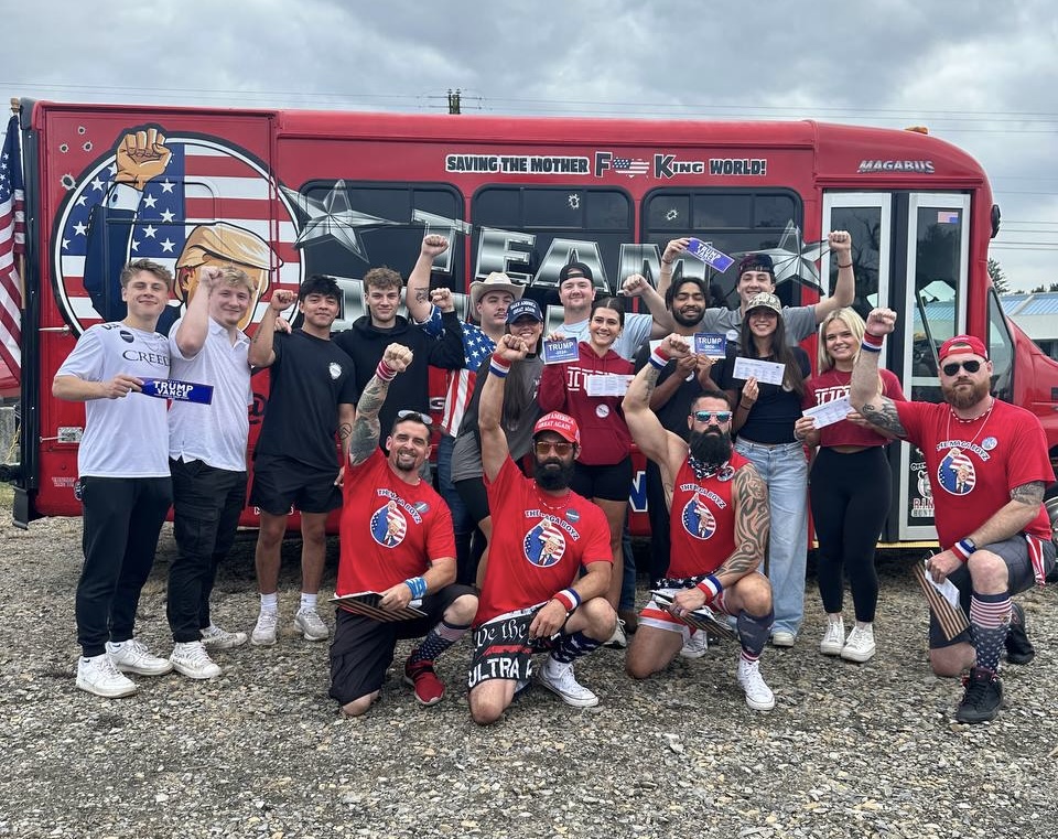 The MAGA Boyz team and volunteers rallying in front of their branded bus