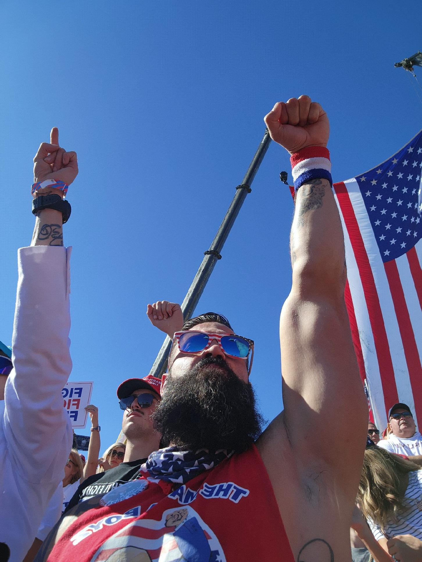 A MAGA Boy with fist raised at a Trump rally